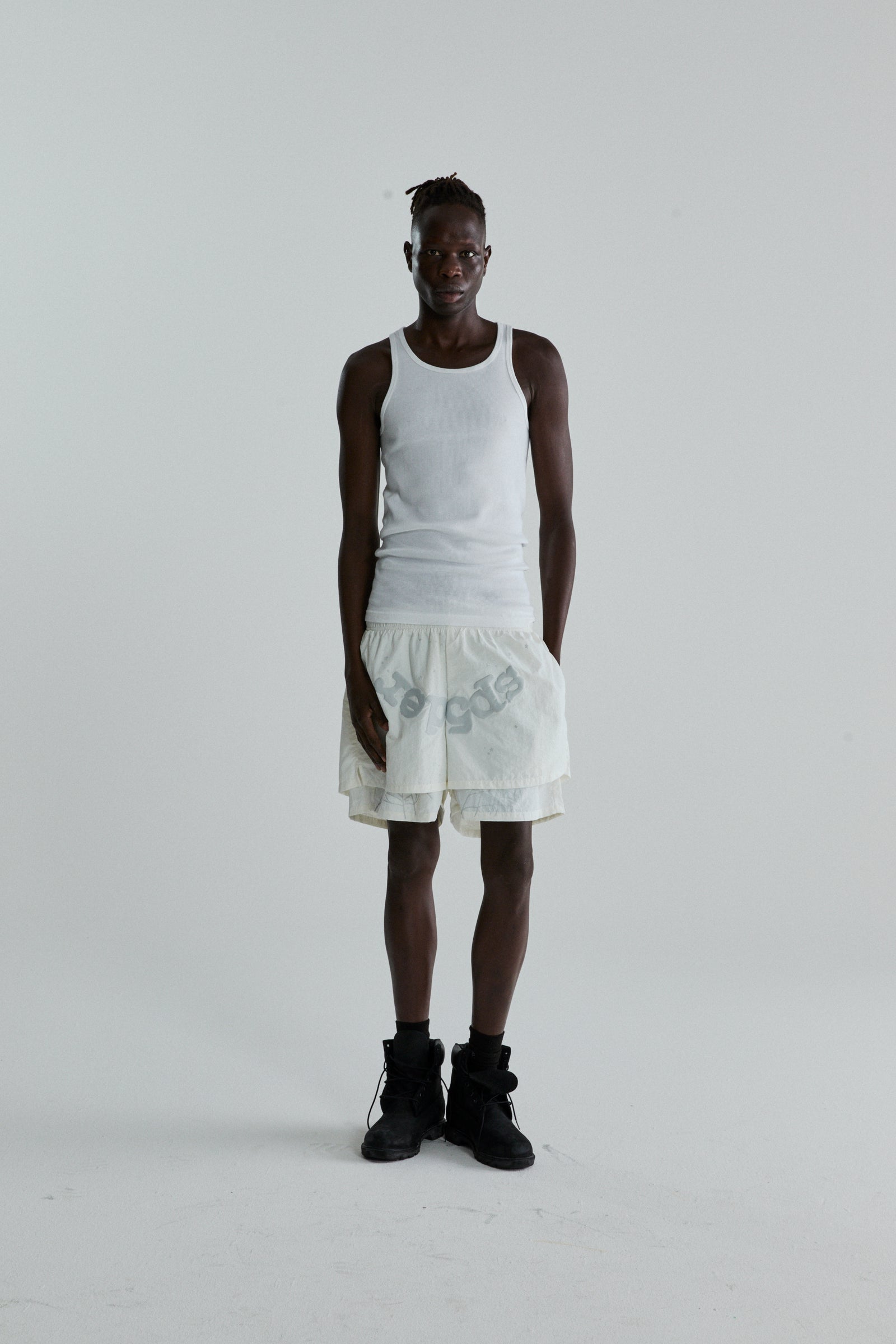 Model wearing OG WEB Double Layer Short in water repellent nylon with "OG SP5DER" text and star print.