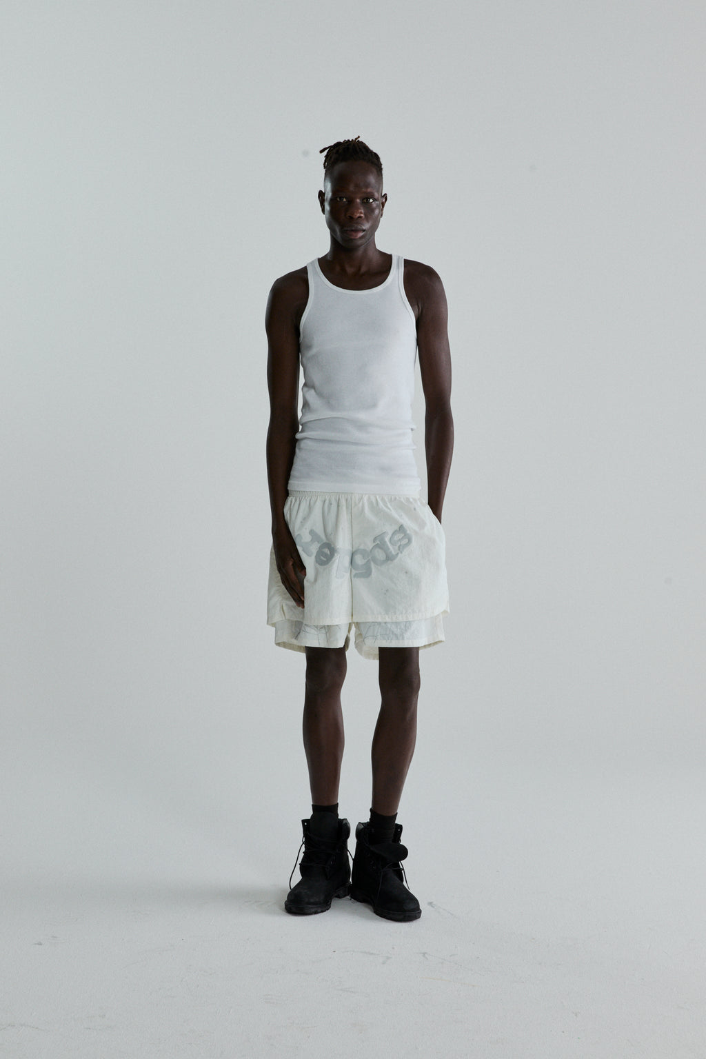 Model wearing OG WEB Double Layer Short in water repellent nylon with "OG SP5DER" text and star print.