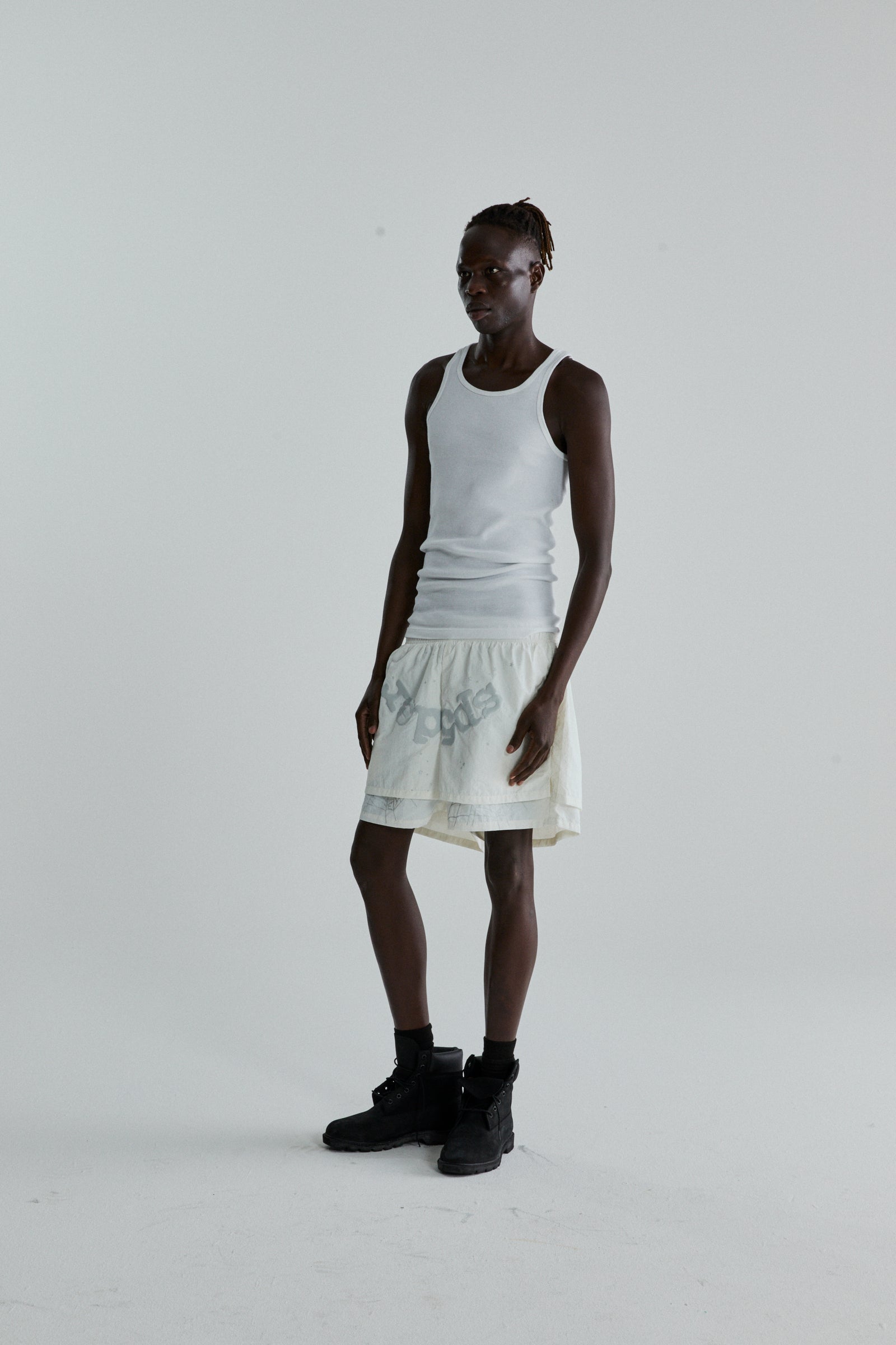 Model wearing OG WEB DOUBLE LAYER SHORT in off-white water repellent nylon with OG SP5DER text and star print.