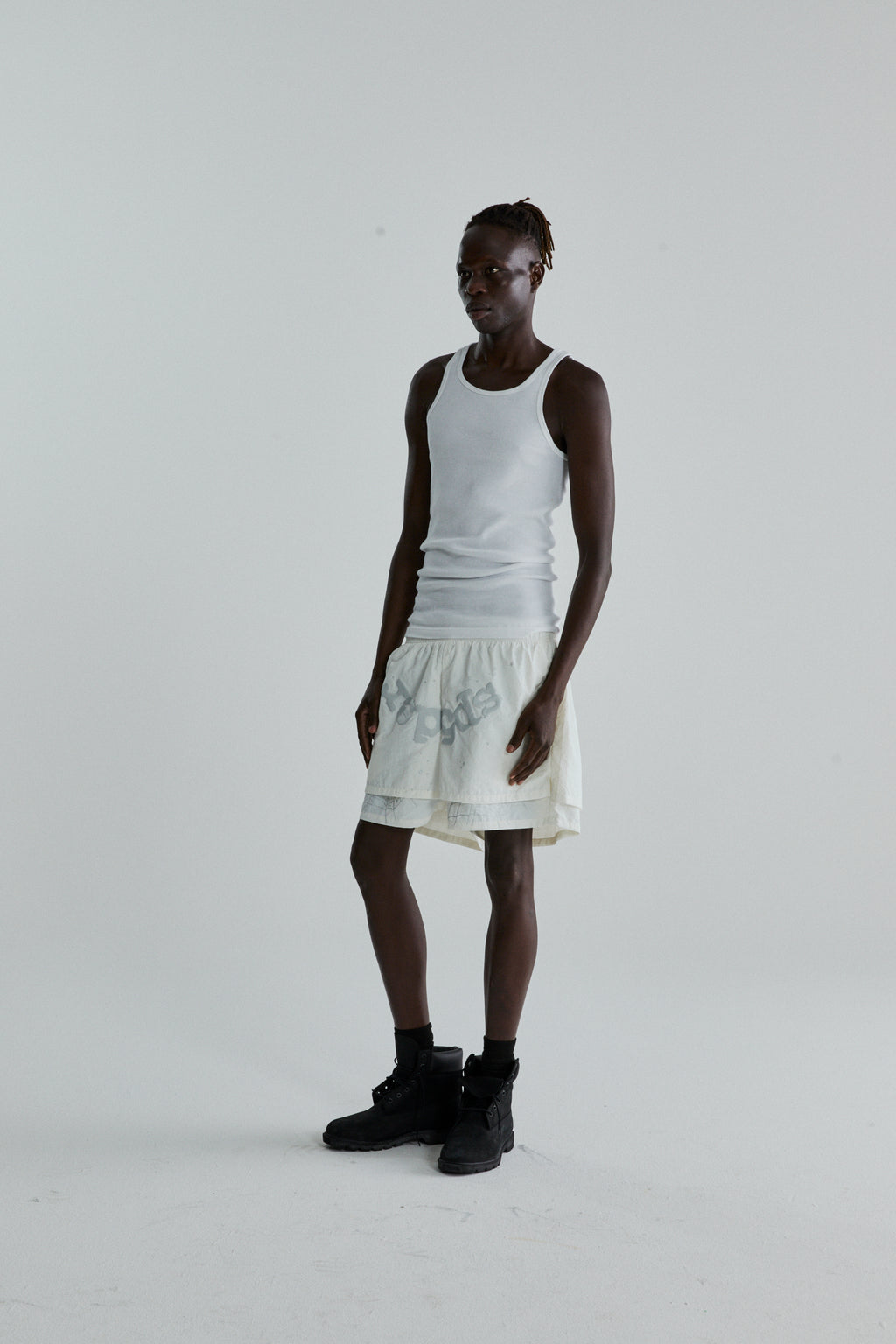 Model wearing OG WEB DOUBLE LAYER SHORT in off-white water repellent nylon with OG SP5DER text and star print.