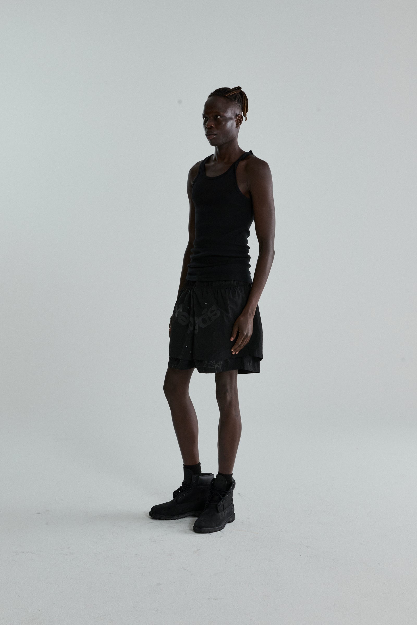 Black OG WEB Double Layer Short with OG SP5DER text and star print, made from water-repellent nylon.