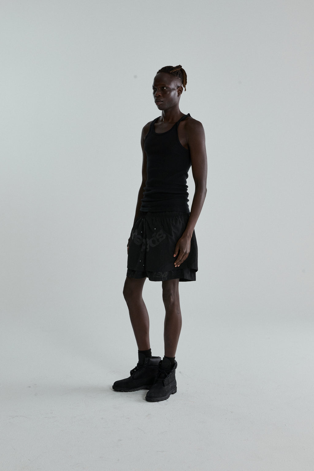Black OG WEB Double Layer Short with OG SP5DER text and star print, made from water-repellent nylon.