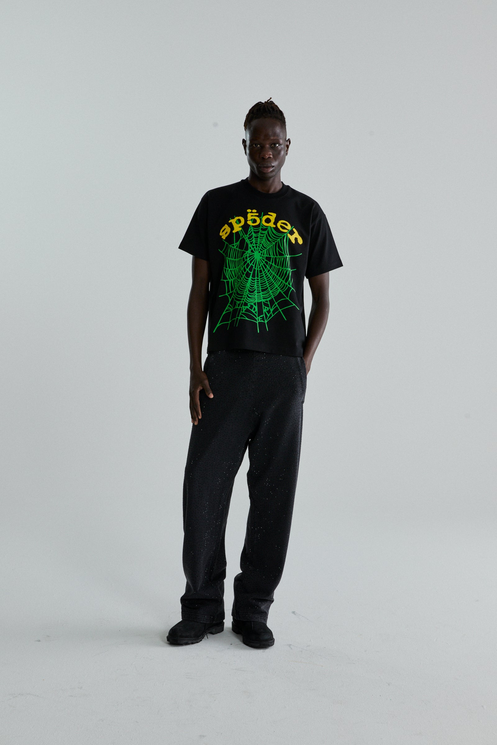 Black OG WEB V2 TEE with green spider web and "sp5der" puff print, worn by a man.