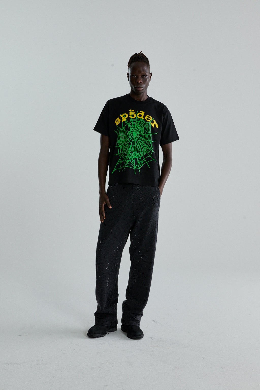 Black OG WEB V2 TEE with green spider web and "sp5der" puff print, worn by a man.