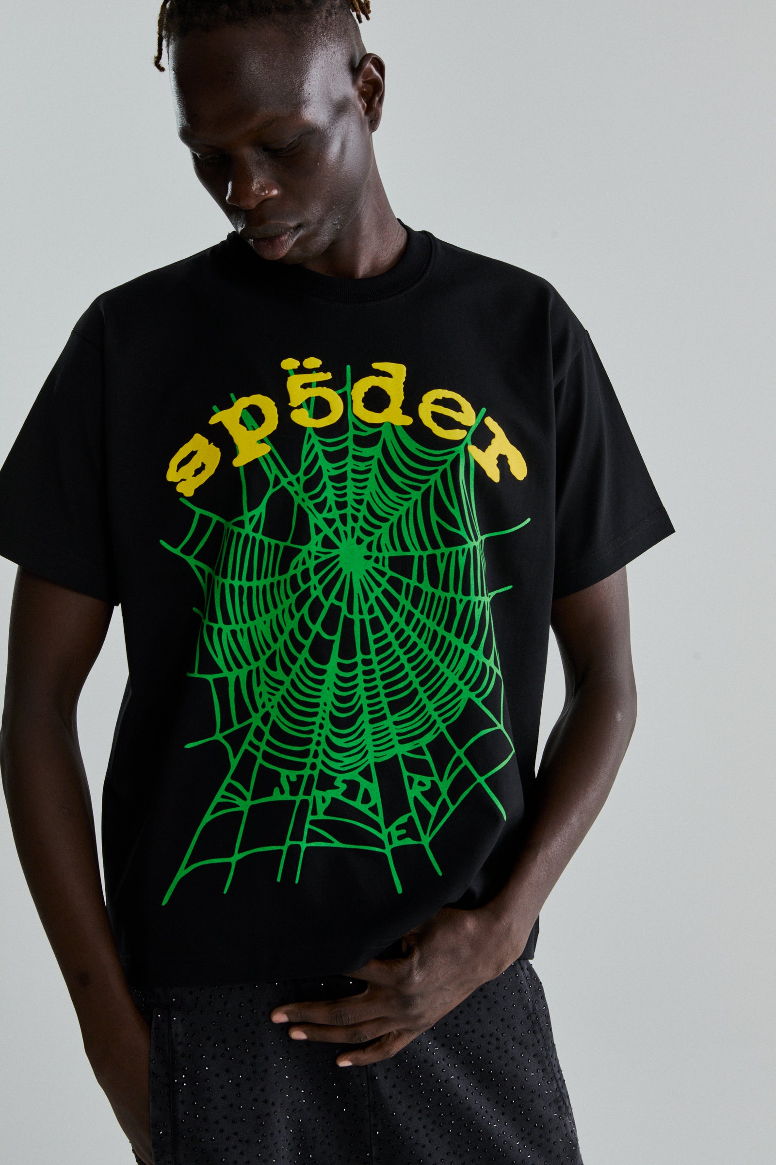 Black cotton OG WEB V2 TEE with green spiderweb and yellow "sp5der" puff print on front.