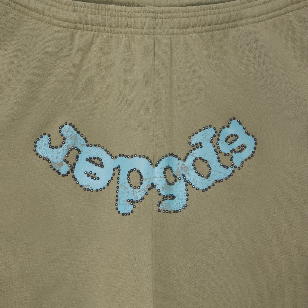 Olive green 13oz cotton fleece sweatpants featuring a faded blue OG logo graphic with metallic stud detailing.