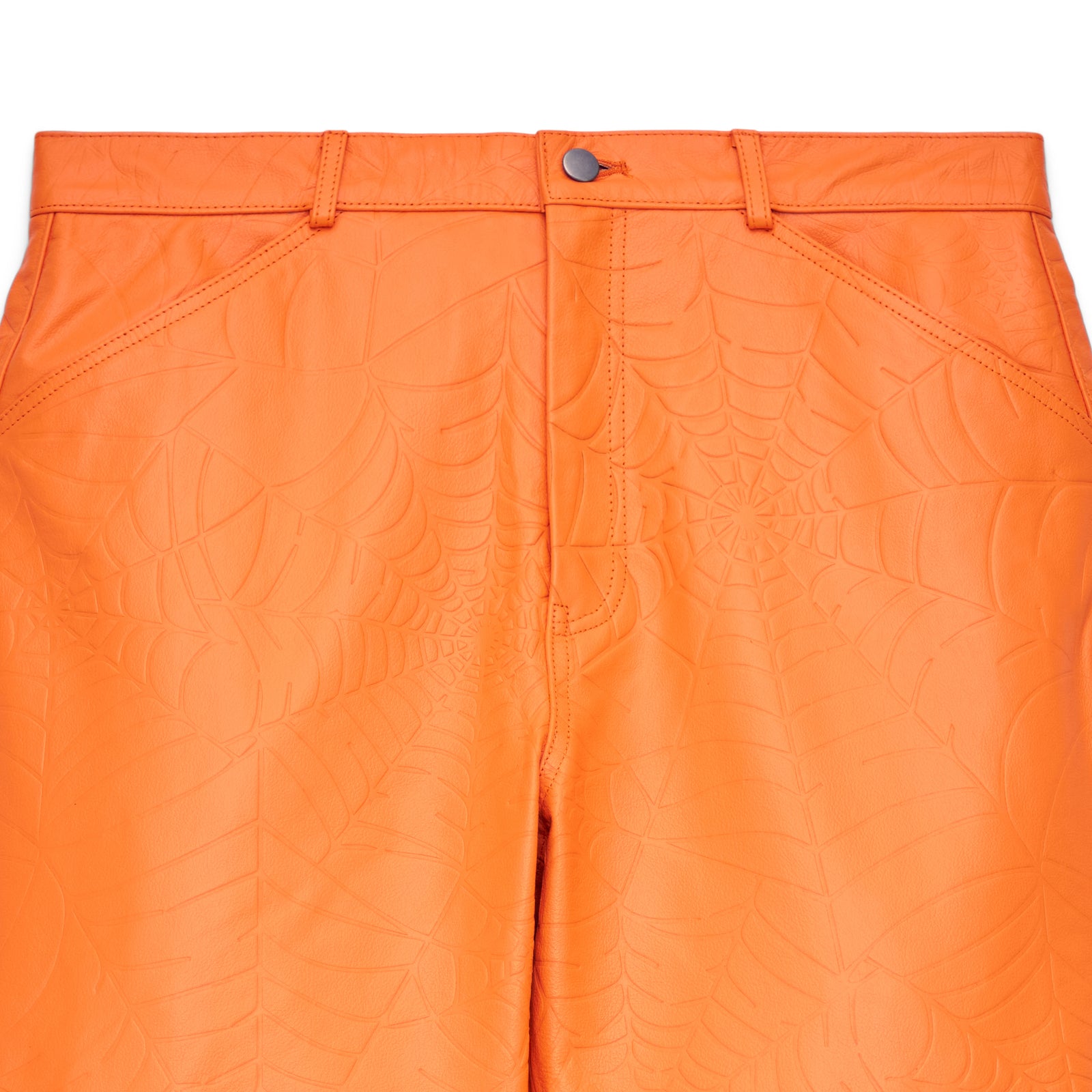 Orange cowskin leather pants with debossed web design, button fly, and belt loops.