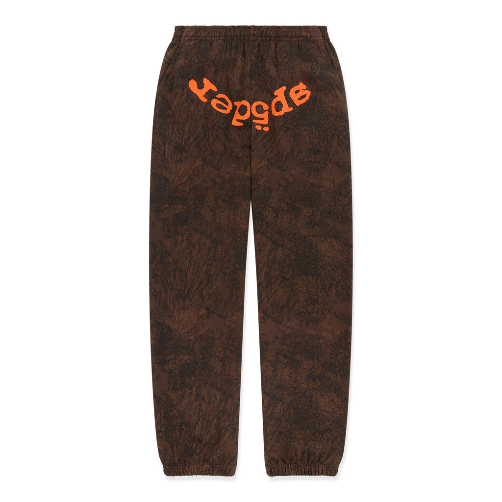 Brown tree camo sweatpants with orange "SP5DER" text at the crotch, elasticized waist and cuffs.