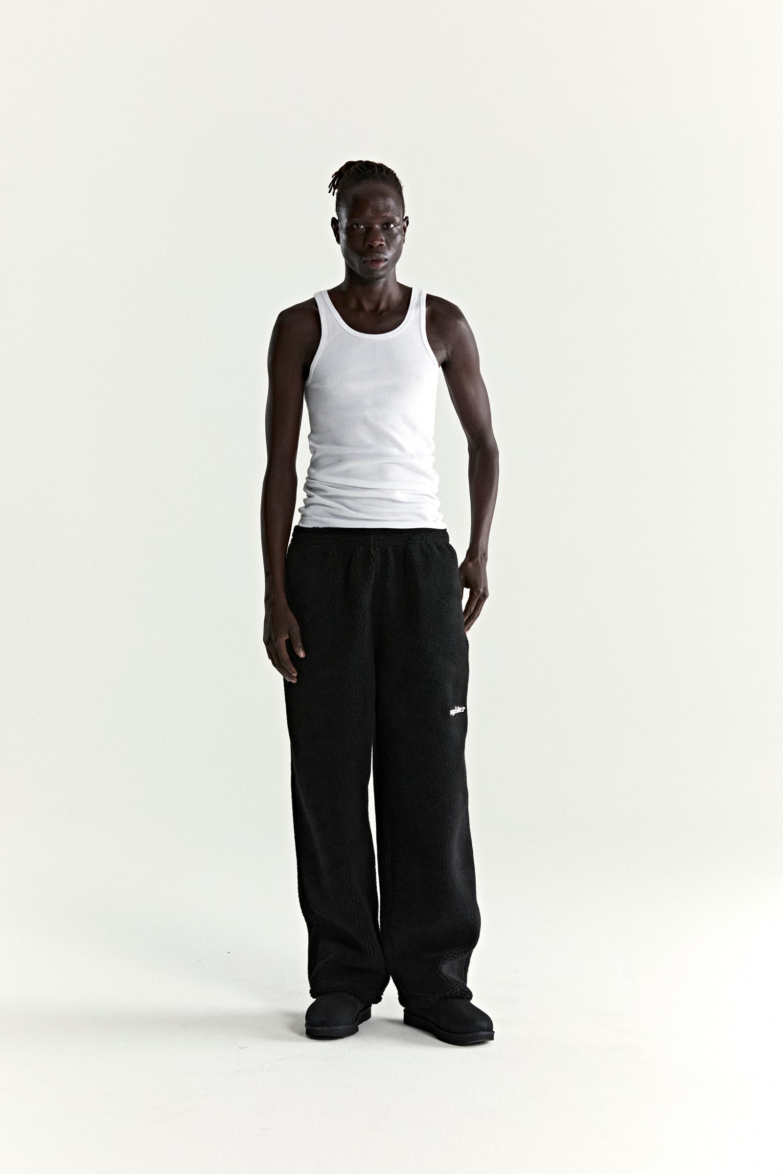 Black TEDDY FLEECE PANT with rubberized logo patch, elasticized drawstring waist, and straight leg fit.