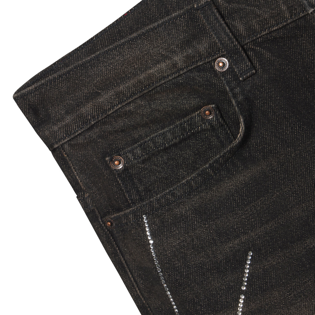 Faded black 13oz denim jeans featuring a rhinestone web graphic design and custom branded copper hardware.