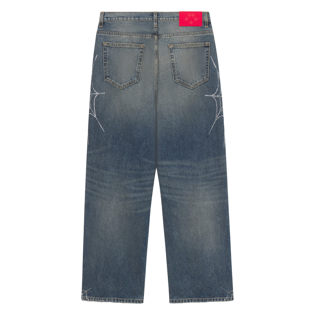 Faded blue straight-leg denim jeans featuring rhinestone web graphic designs and a branded red leather back patch.