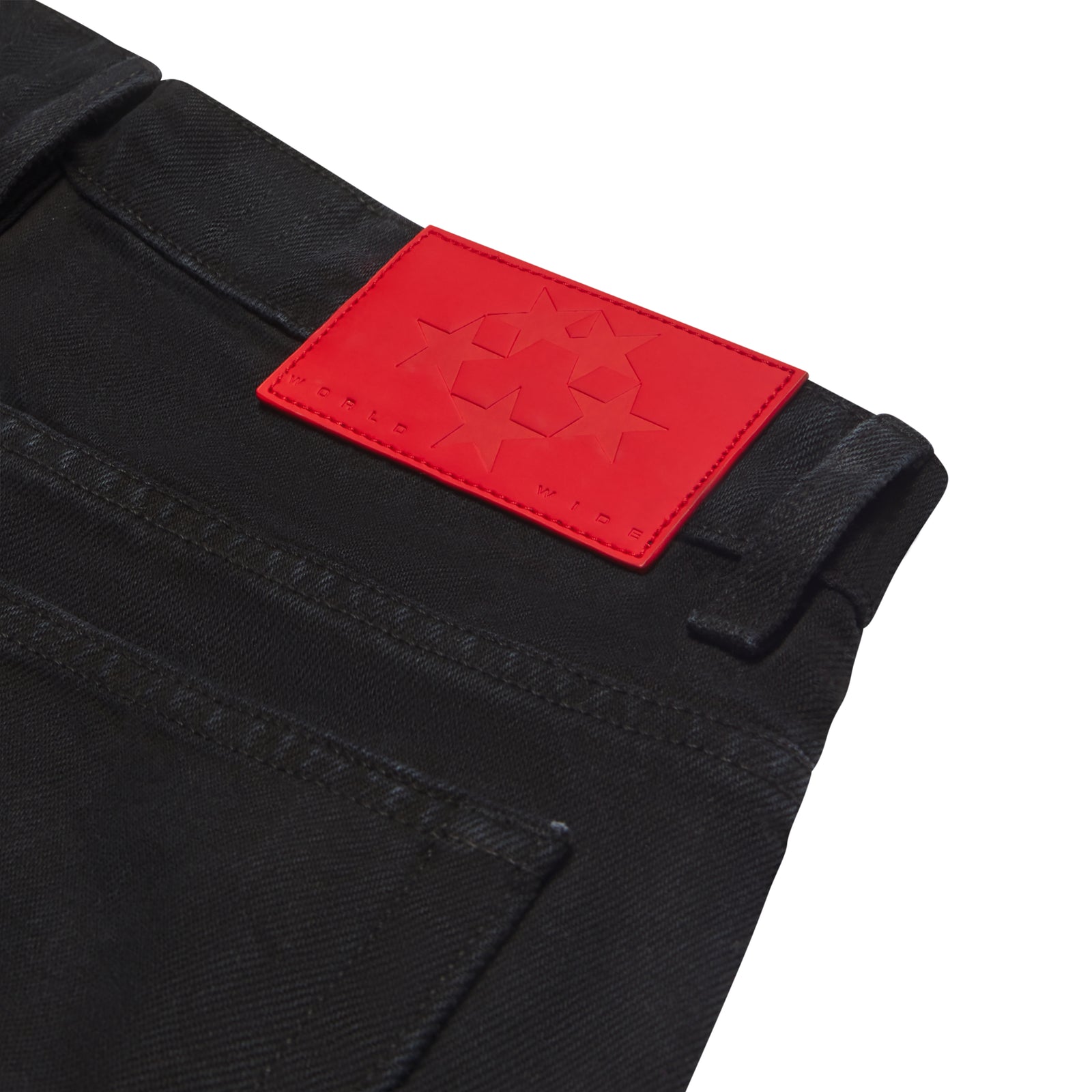 Black 13oz denim jeans with a vibrant red branded leather back patch.