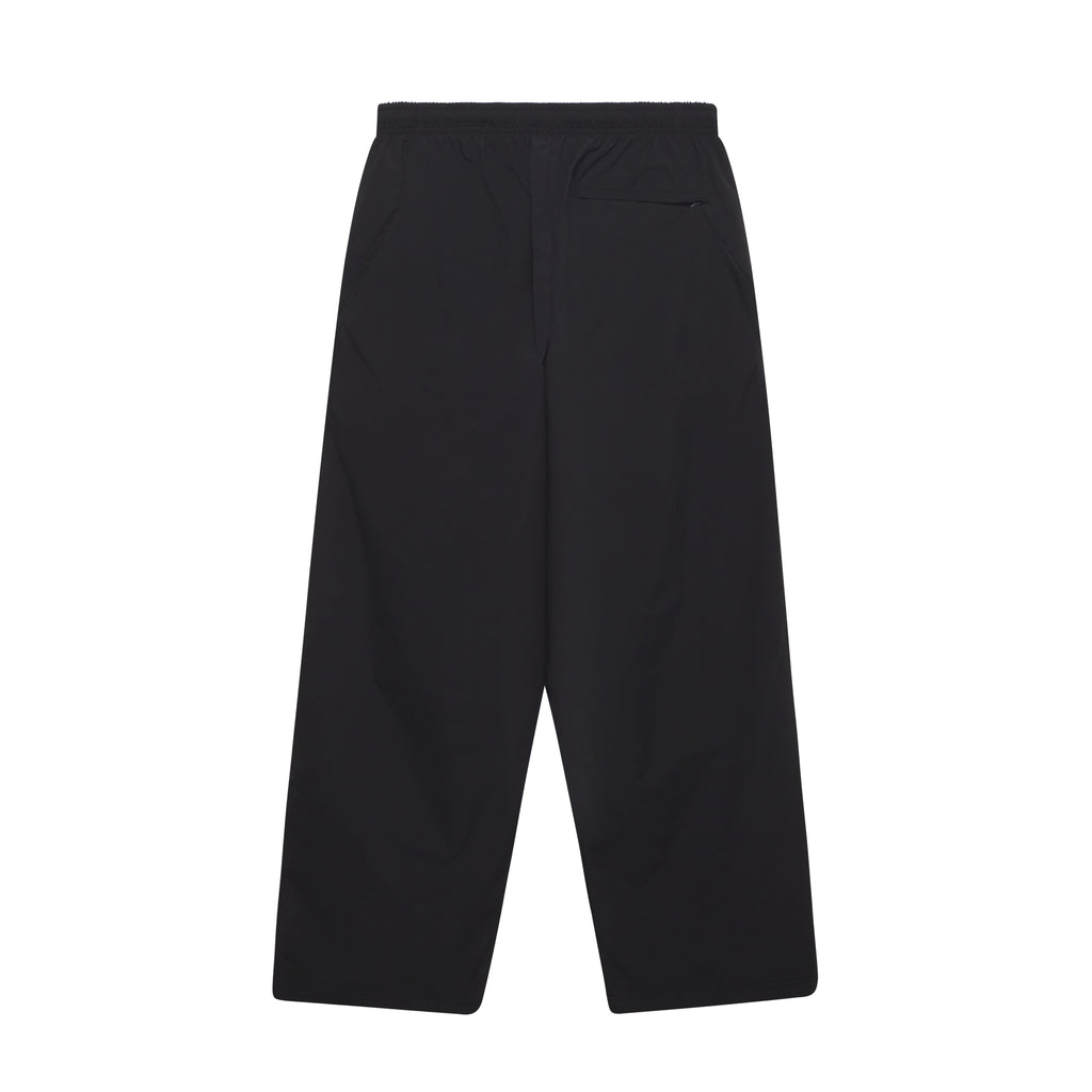 Black nylon wide-leg track pants featuring an elastic waistband and side pockets in a minimalist design.