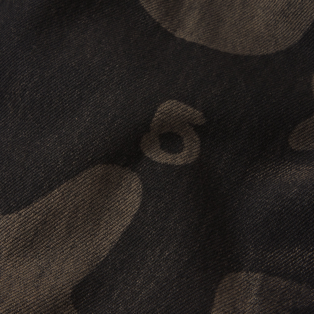 Dark denim fabric featuring a faded, tonal Beluga graphic print with a textured twill weave.