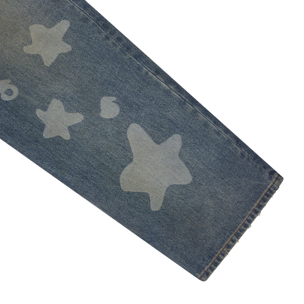 Blue denim jeans featuring a faded white star graphic print and a classic straight leg fit.