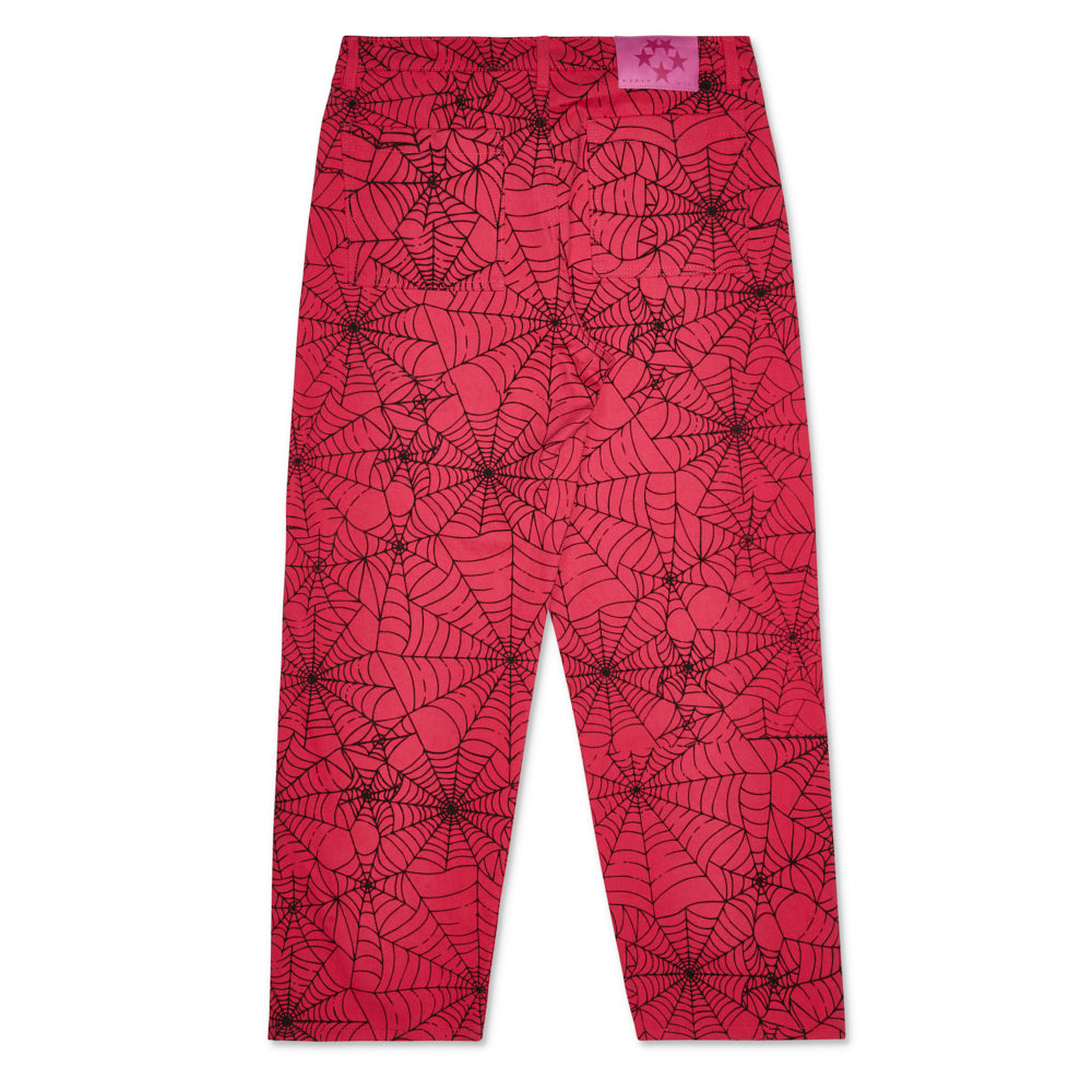 Pink denim work pants with an all-over black spider web print.