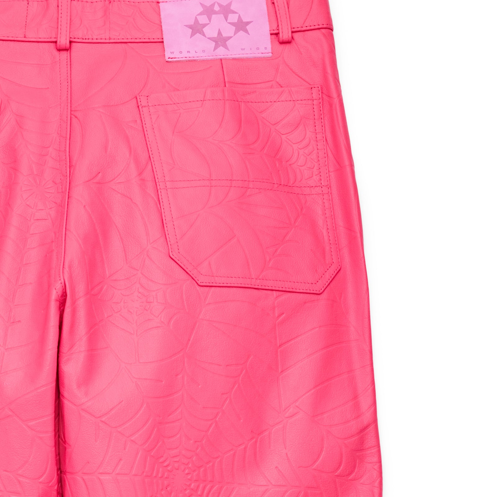 Hot pink cowskin leather pants with debossed web design and pink suede logo patch.