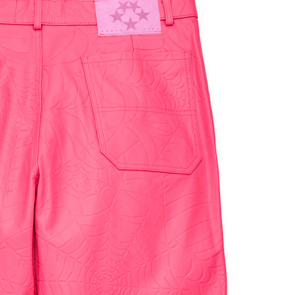 Hot pink cowskin leather pants with debossed web design and pink suede logo patch.