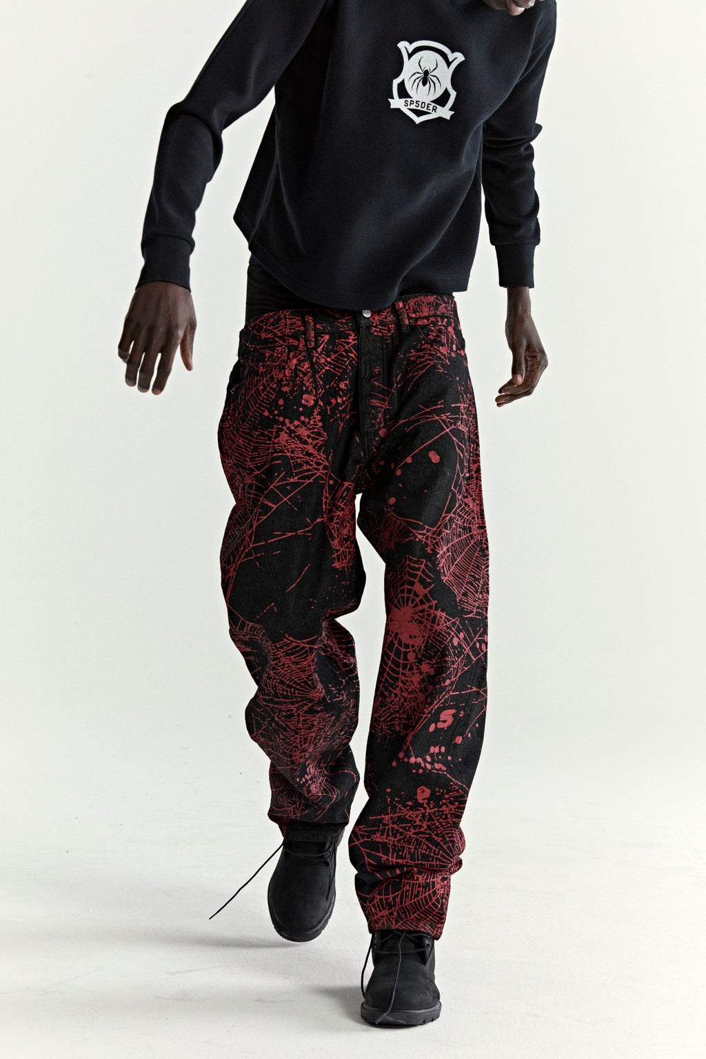 V2 WEB DENIM pants: black denim with all-over red web print, classic straight leg.