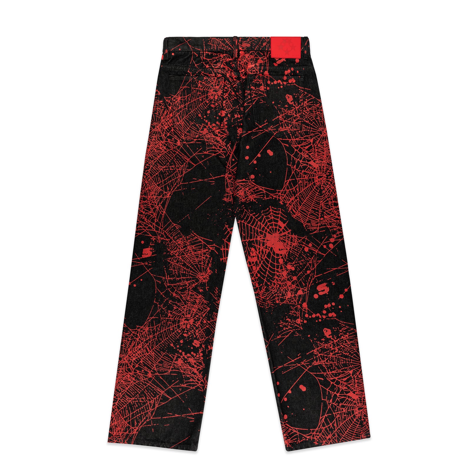 Black denim pants with all-over red web print, classic straight leg, and a red leather patch.