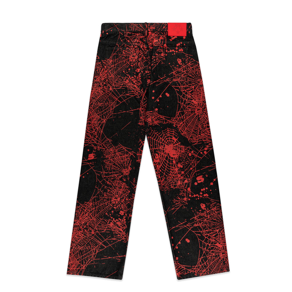 Black denim pants with all-over red web print, classic straight leg, and a red leather patch.