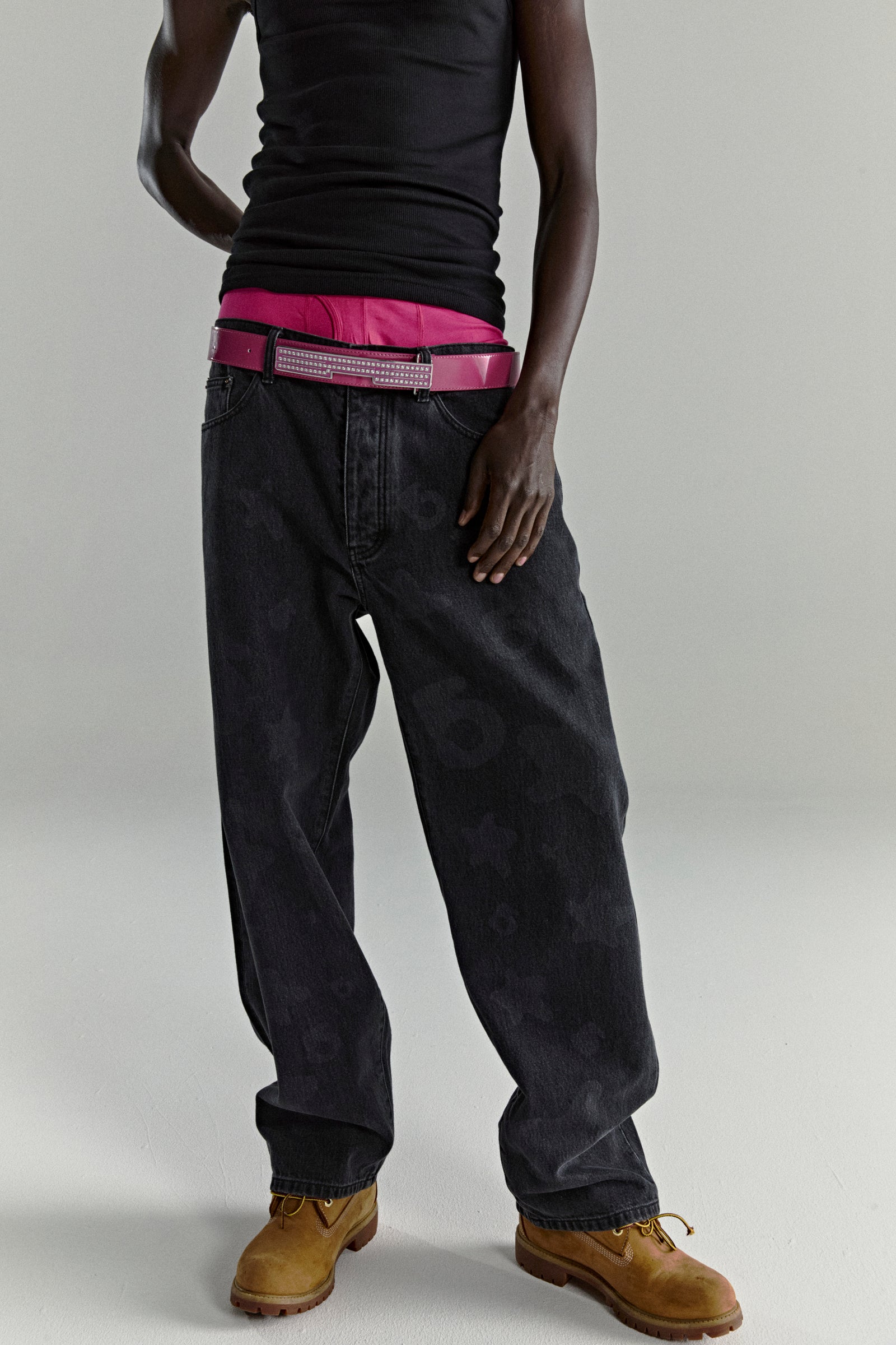 BELUGA DENIM faded wash black jeans with subtle design, straight leg fit, and pink belt.