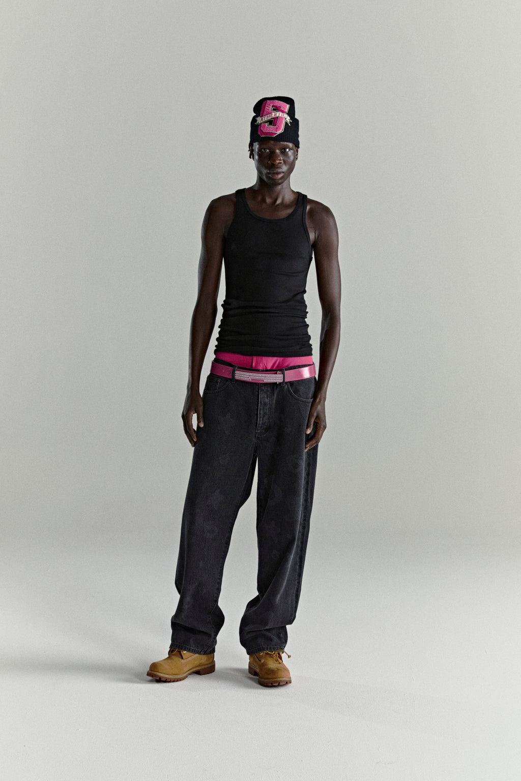 BELUGA DENIM faded wash, straight leg jeans with branded hardware and leather back patch, worn by a model.