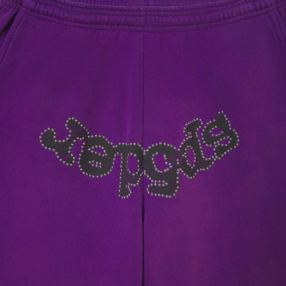 Faded purple cotton fleece sweatpants featuring a black OG logo graphic outlined with metallic stud detailing.