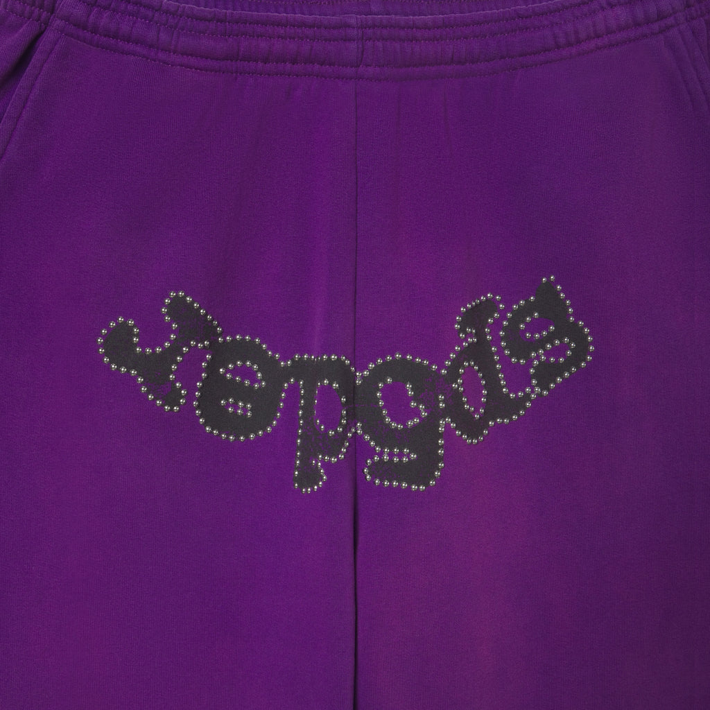 Faded purple cotton fleece sweatpants featuring a black OG logo graphic outlined with metallic stud detailing.
