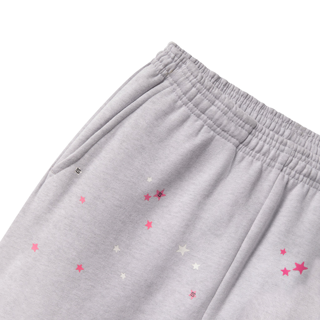Grey cotton fleece sweatpants with an elasticized waistband and scattered pink and white star graphic prints.