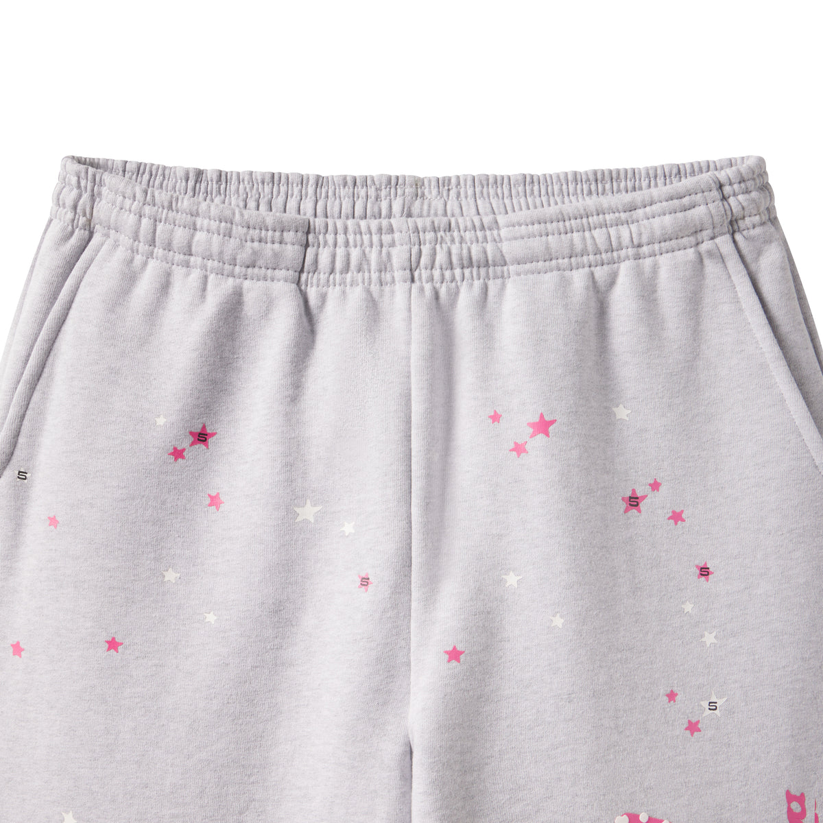 Grey cotton fleece sweatpants featuring a scattered pink and white star graphic print and an elasticized waistband.