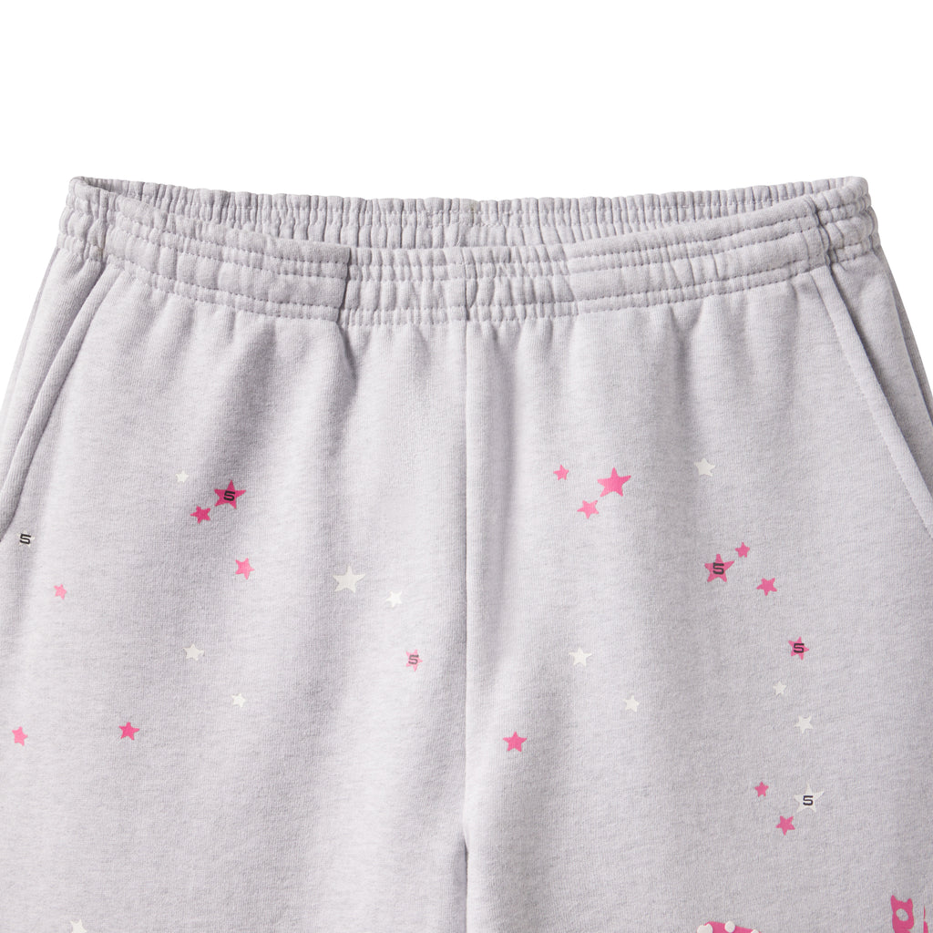 Grey cotton fleece sweatpants featuring a scattered pink and white star graphic print and an elasticized waistband.