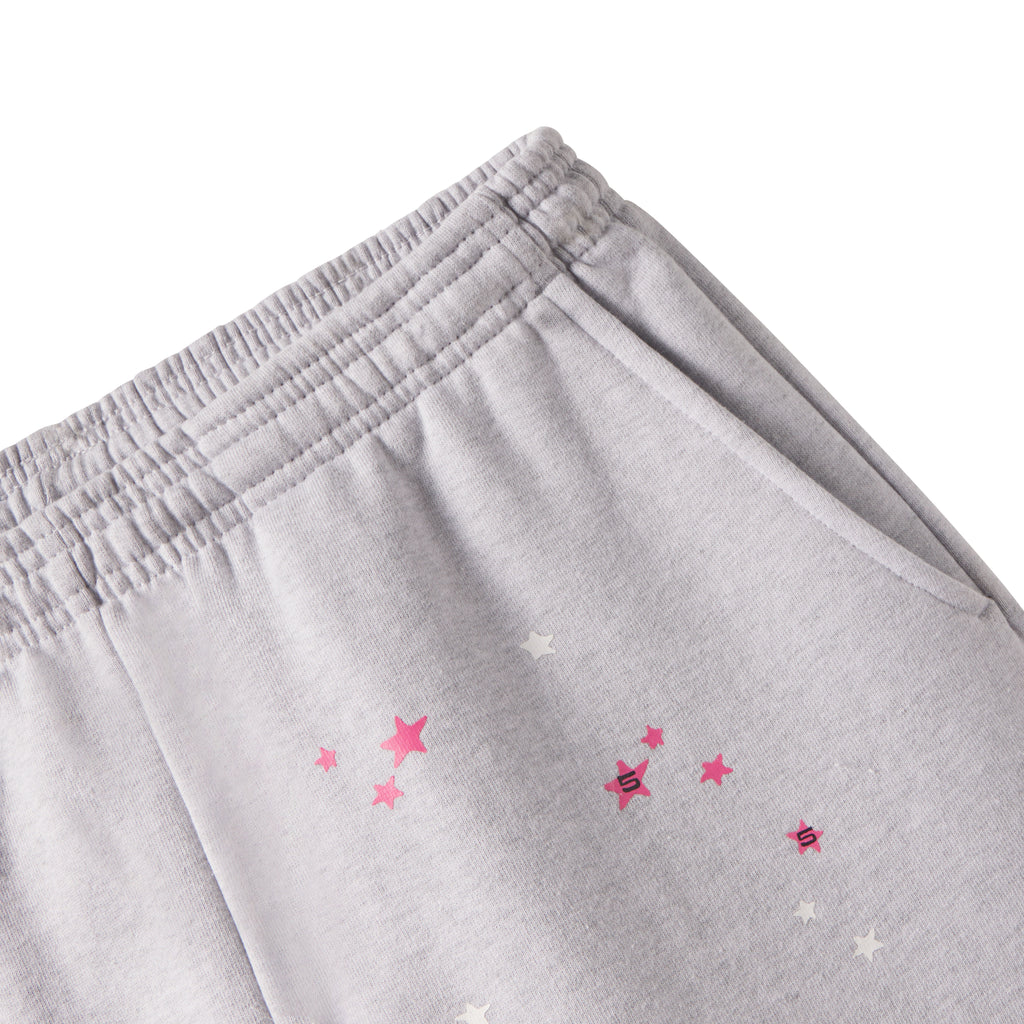 Grey cotton fleece sweatpants with elasticized waistband and scattered pink and white star graphic print.