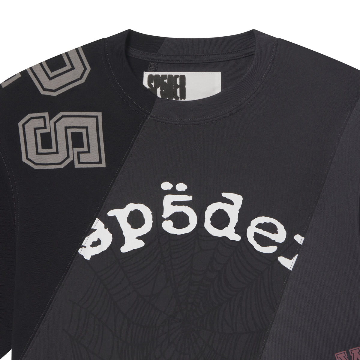 Black cotton crewneck tee with asymmetrical color-block panels, collegiate-style lettering, and web graphic print.