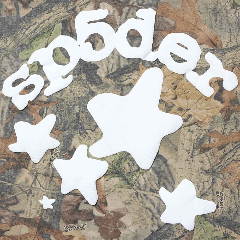REAL TREE BELUGA LS TEE with white 'SP5DER' puff print and stars on camouflage fabric.