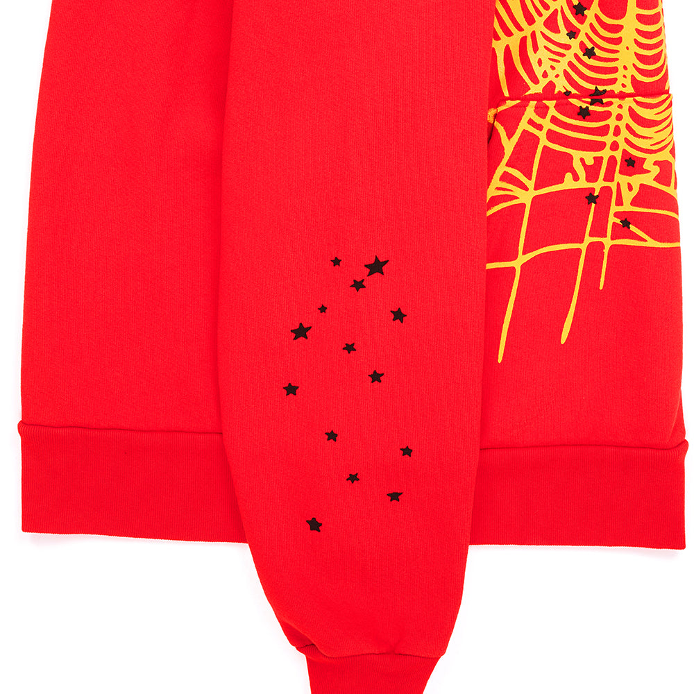 Red P*NK V2 HOODIE sleeve with black stars and yellow SP5DER web print.