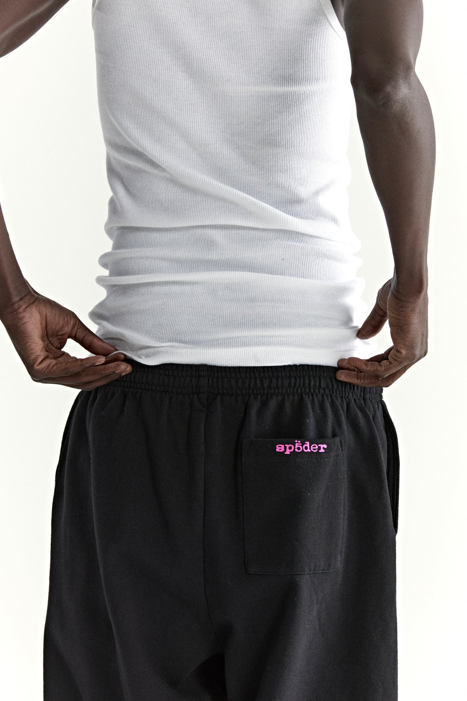 Black ARACH SWEATPANT with pink "sp5der" puff print on back pocket, 100% cotton fleece.
