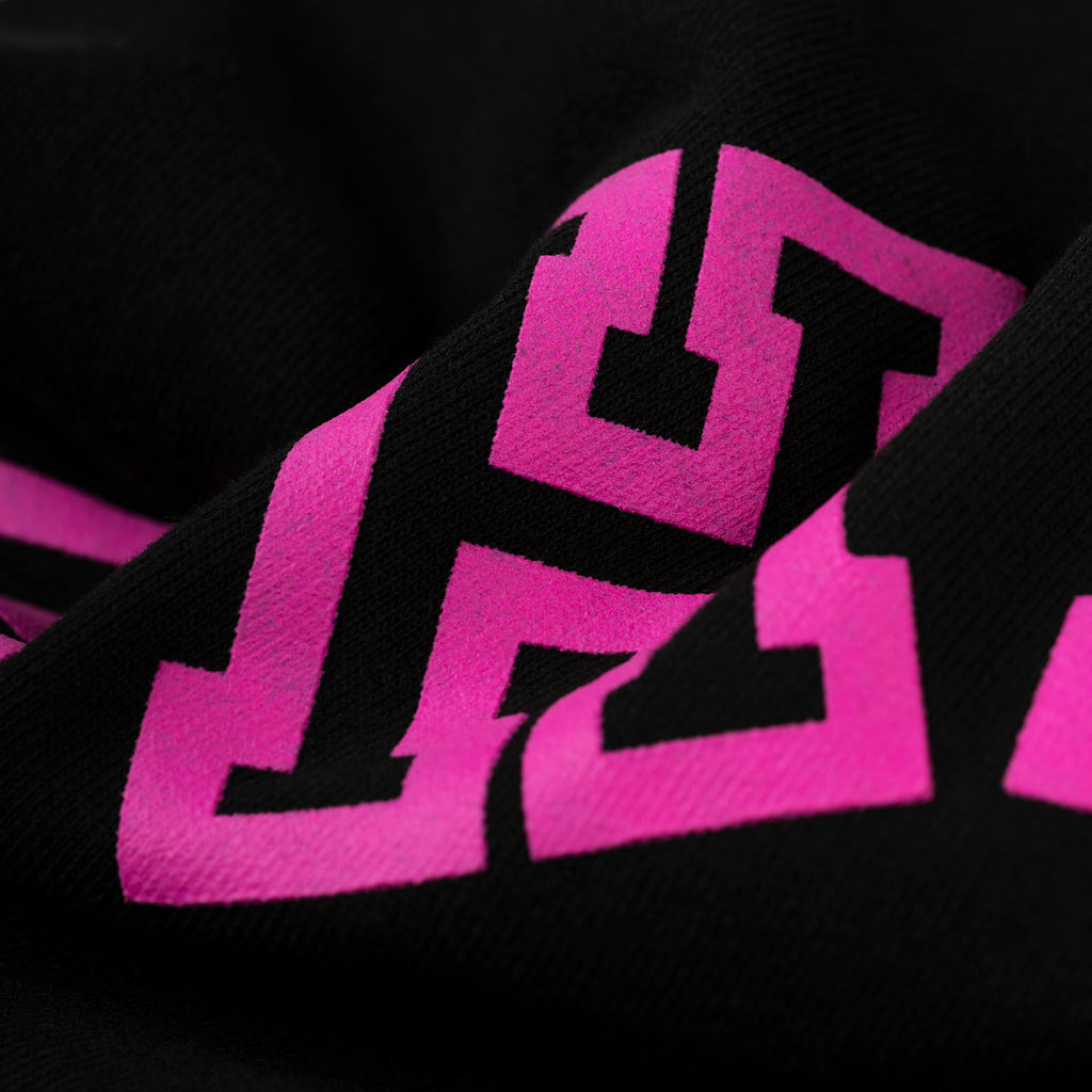 Black 13oz cotton fleece ARACH SWEATPANT with vibrant pink arched text puff print.