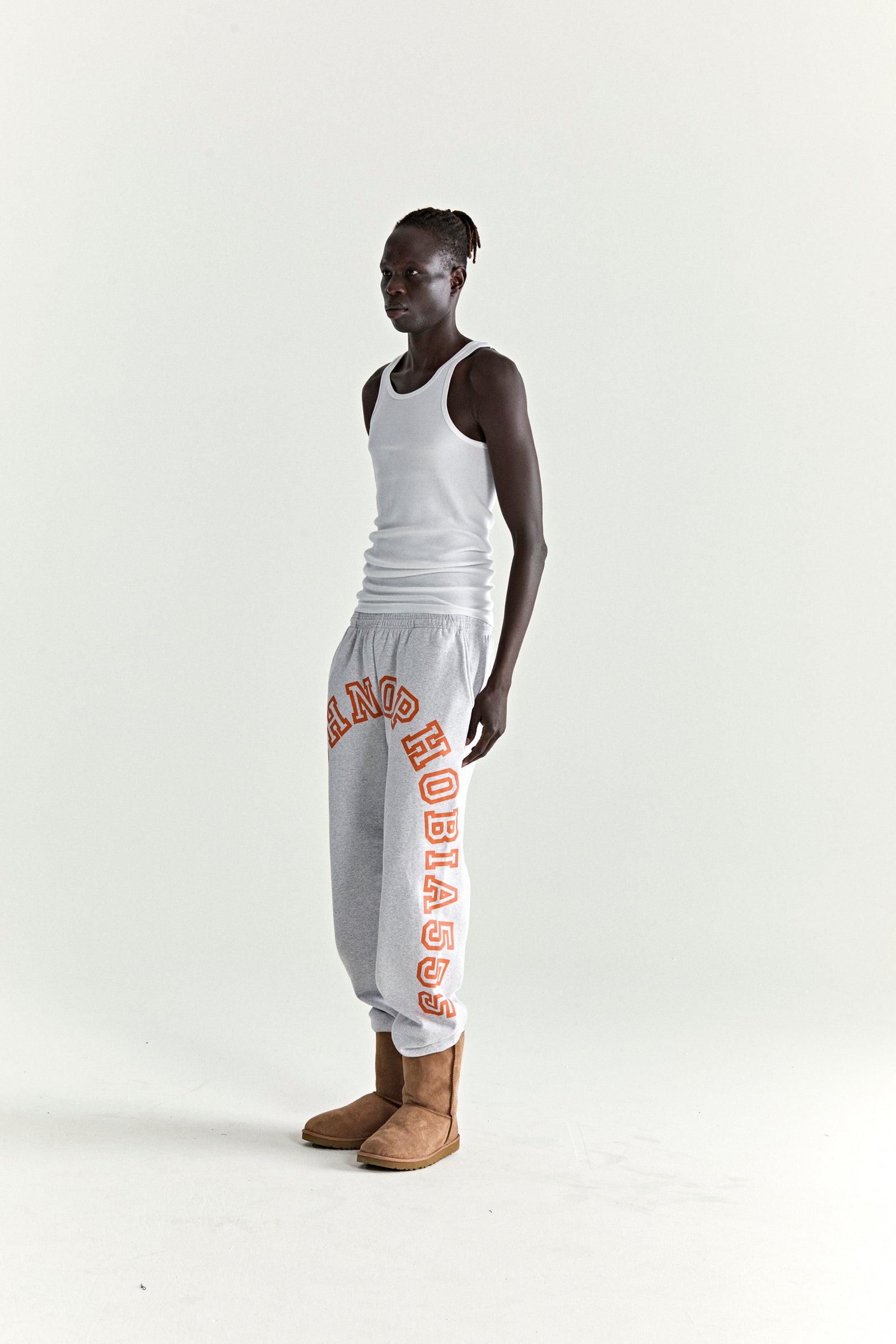 Grey ARACH SWEATPANT with arched red "ARACHNOPHOBIA" text, elasticized waist/cuffs, and three pockets.