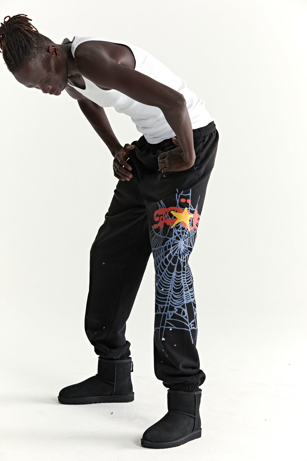Black HEAVY WEB SWEATPANTS with SP5DER web graphic, scattered stars, and elasticized cuffs.