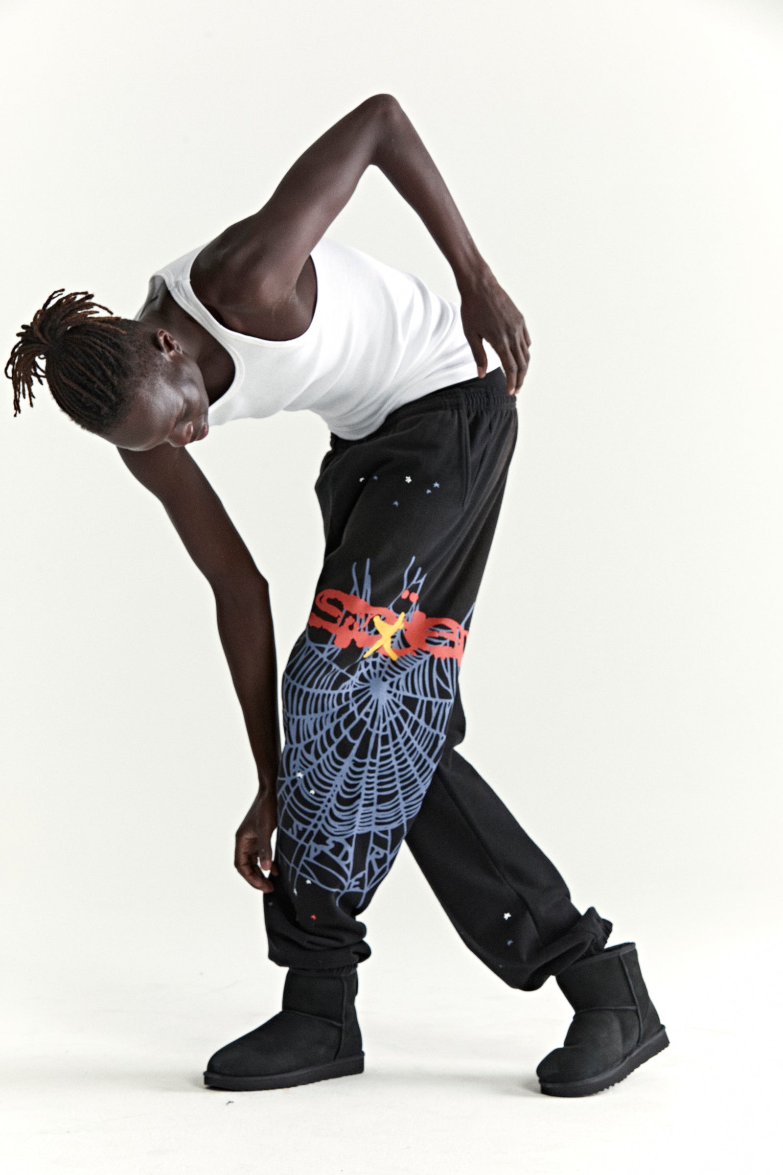 Black HEAVY WEB SWEATPANT with blue SP5DER web graphic, red "SP5DER" text, and scattered stars.