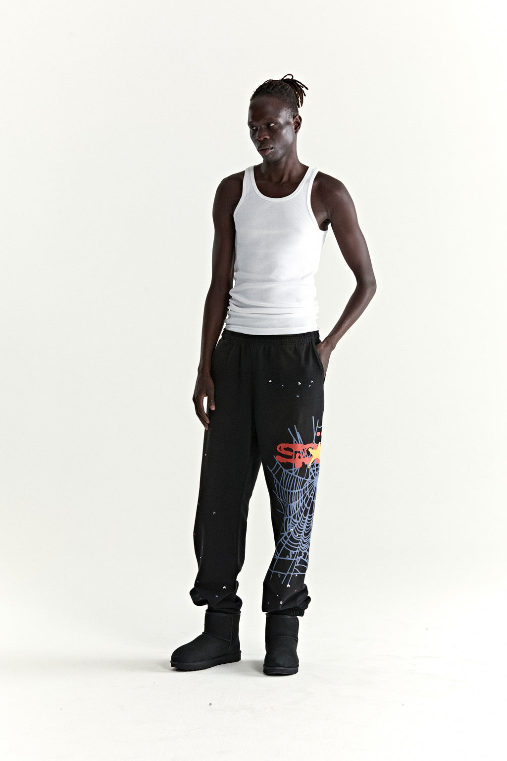 Black HEAVY WEB SWEATPANTS with SP5DER web graphic, scattered stars, and elasticized cuffs.