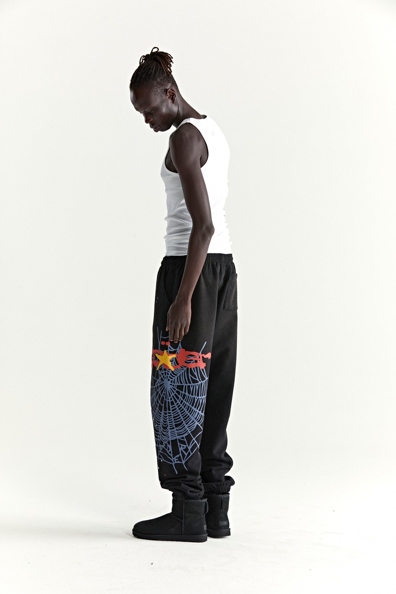 Black HEAVY WEB SWEATPANT with colorful SP5DER web graphic, scattered stars, and elasticized cuffs.