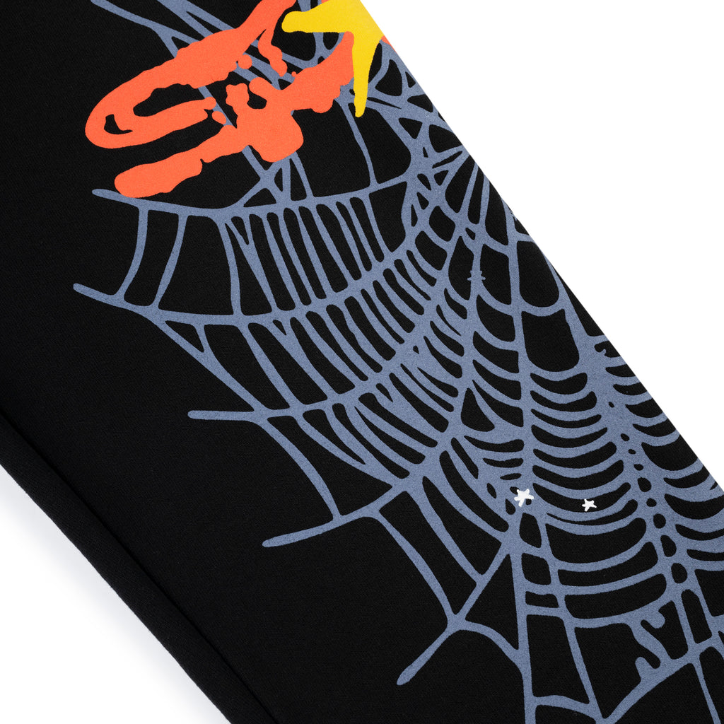 Black cotton fleece sweatpant with grey SP5DER web graphic, scattered stars, and colorful puff/discharge print.