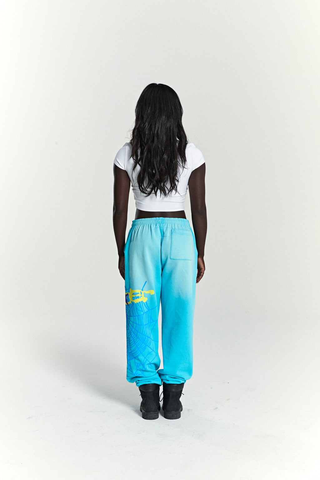 Turquoise HEAVY WEB SWEATPANTS with yellow SP5DER web graphic and scattered stars on 13oz cotton fleece.