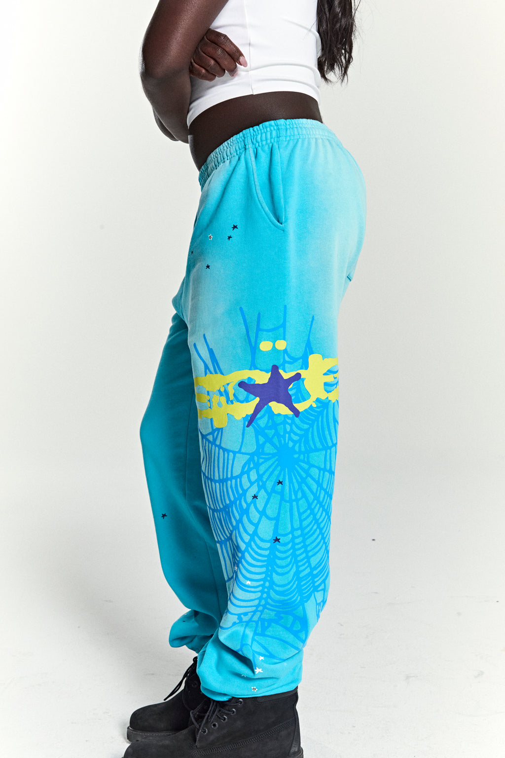 Heavy Web Sweatpant in turquoise 13oz cotton fleece with SP5DER web graphic, scattered stars, and elasticized cuffs.