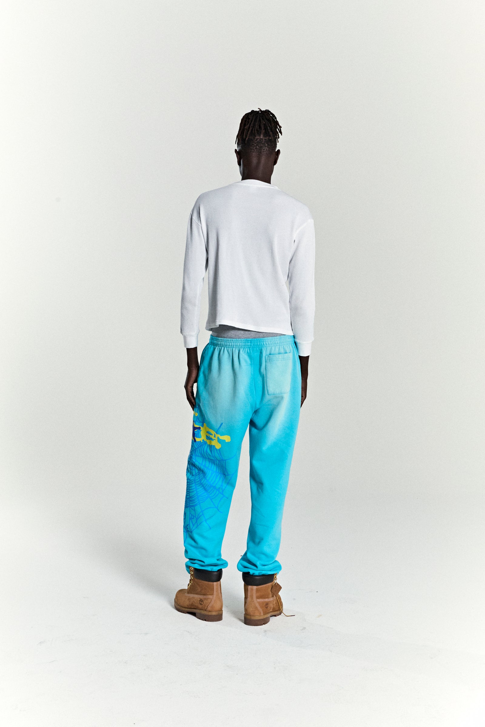 Blue HEAVY WEB SWEATPANT with SP5DER web graphic, scattered stars, and elasticized cuffs.
