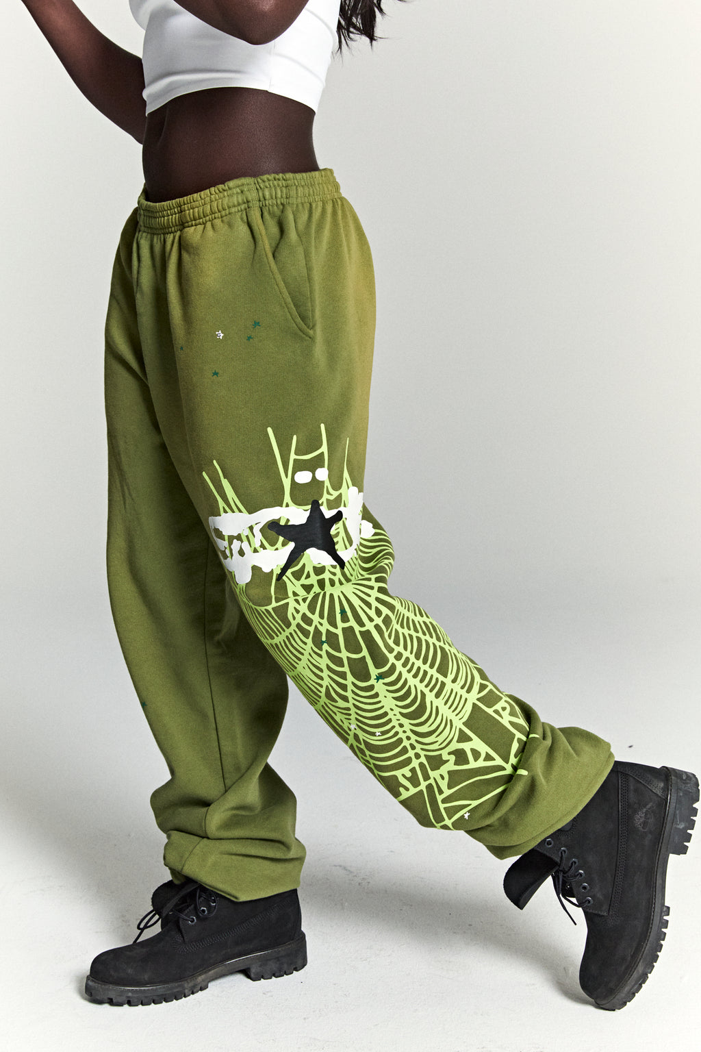 Olive green HEAVY WEB SWEATPANT with SP5DER web graphic, scattered stars, and black star puff print.