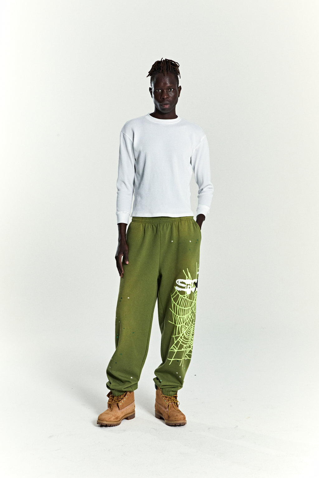 Heavy Web Sweatpants in olive green 13oz cotton fleece with SP5DER web and scattered star print.