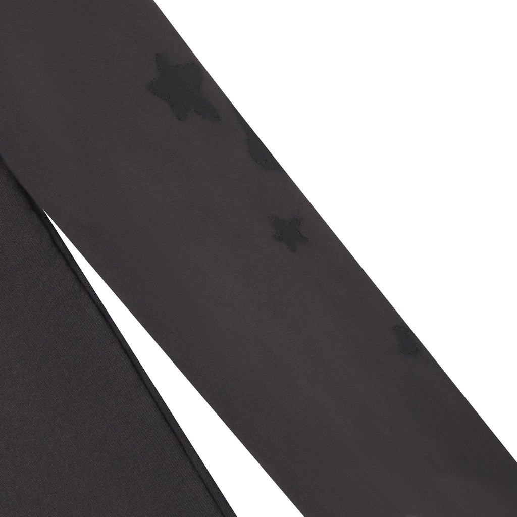 Beluga grey 100% cotton fleece sweatpants featuring distressed star graphic designs along the leg.